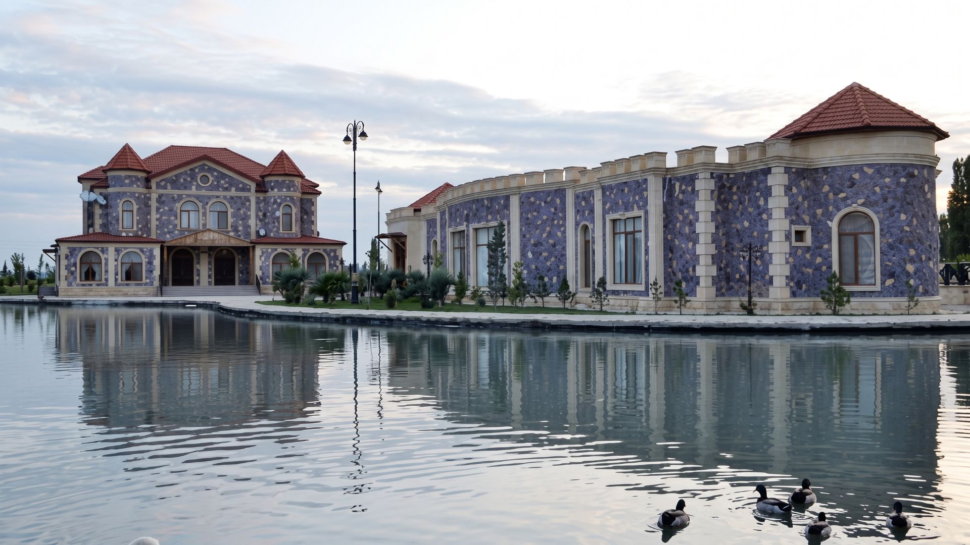 Stone-faced buildings beside water in the supplied Ujar accommodation image